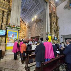The procession after mass with one of the crosses youth bring around to parishioners
