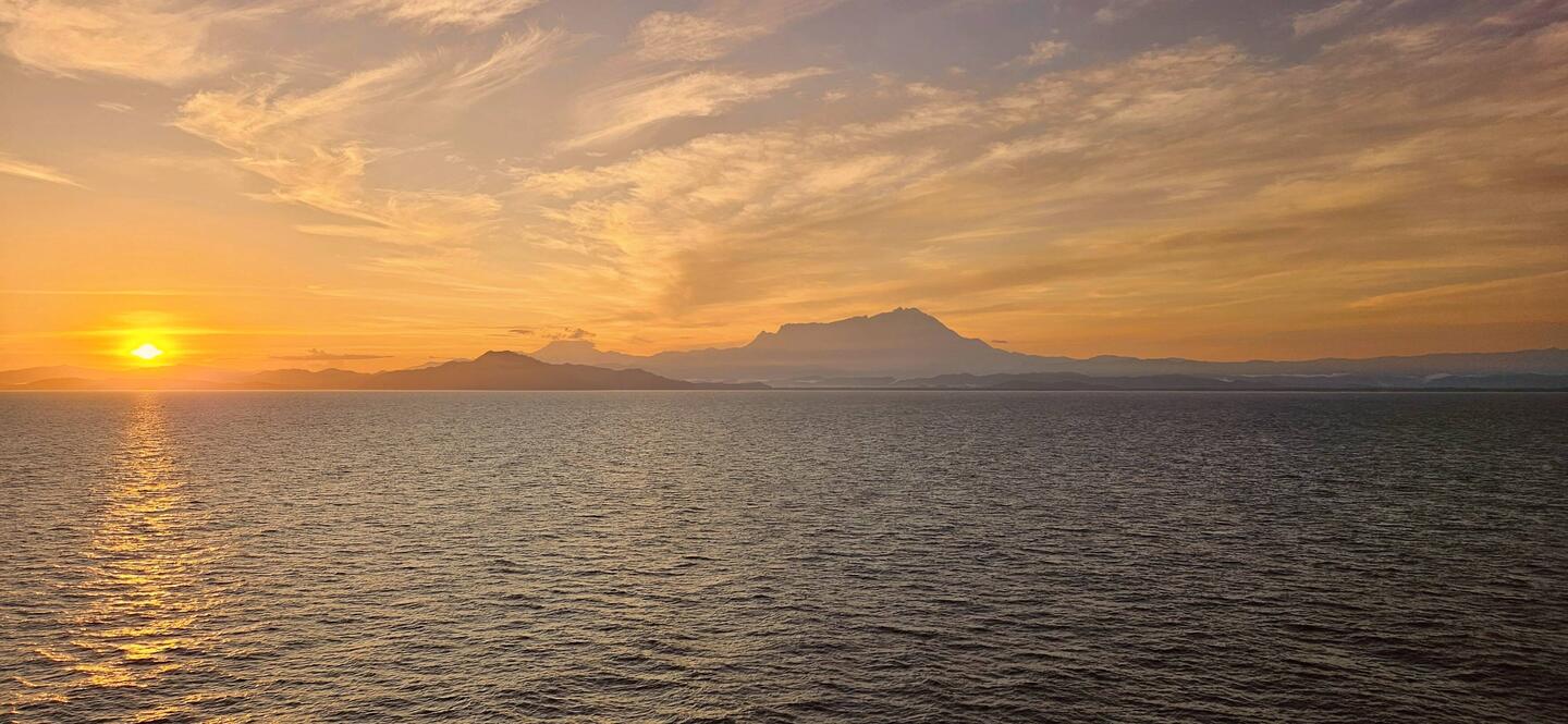 Sunrise behind Mount Kinabalu.
