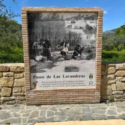 This sign with an old photo of smiling washerwomen at the beginning of the river paseo...