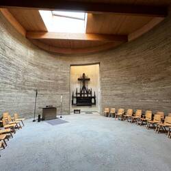 Inside the chapel, with the damaged altarpiece from the original church in the centre