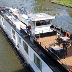 The Captain of the Fluvius on top deck