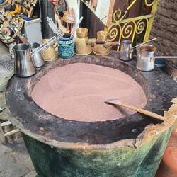 Coffee traditionally made in hot brown sand.