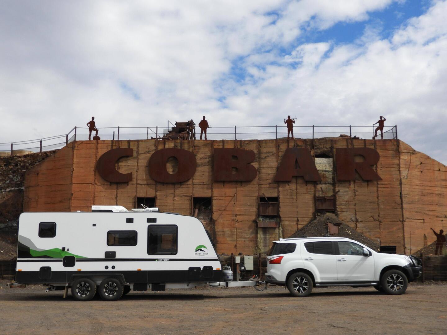 In front of the COBAR sign - car and van are still white - how long for?