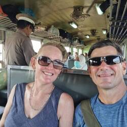 3.5 hours south of Bangkok, traveling in 3rd class ($5 each), with beautiful paddy field scenery.