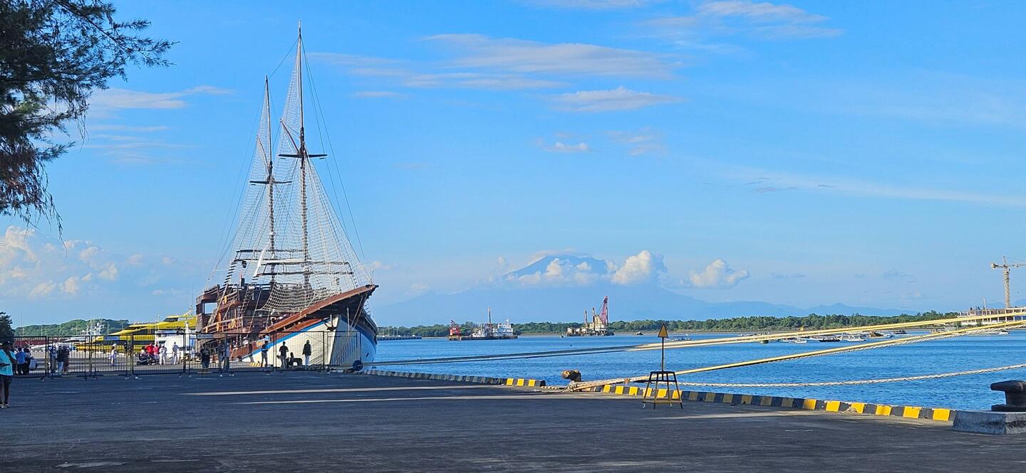 Mount Agung visible in the distance from the port.