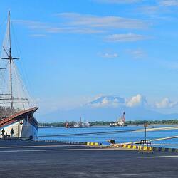 Mount Agung visible in the distance from the port.