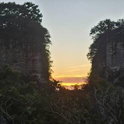 Sun setting behind some of the huge blocks, which I guess are remains of a quarry?