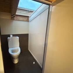 Yep, that's a beam about 4 feet off the floor, right over the toilet. Do not get up fast!