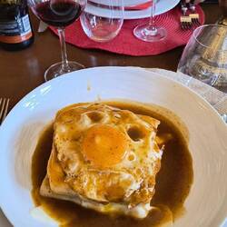 Francesinha (Porto's famous sandwich: beef, ham, sausage, cheese, fried egg, tomato sauce.