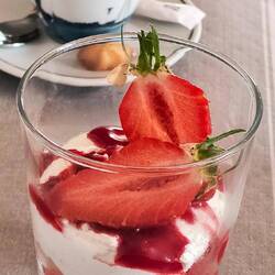 Strawberries with Chantilly cream over cookie crumble.