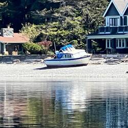 Boat sitting on the beach with low tide.