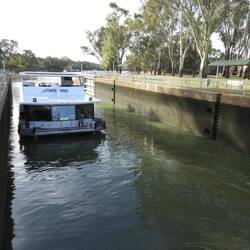 Houseboat passing through Loch 11