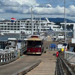 Friday Harbor Trolley on the main dock and a cruise ship in the background.