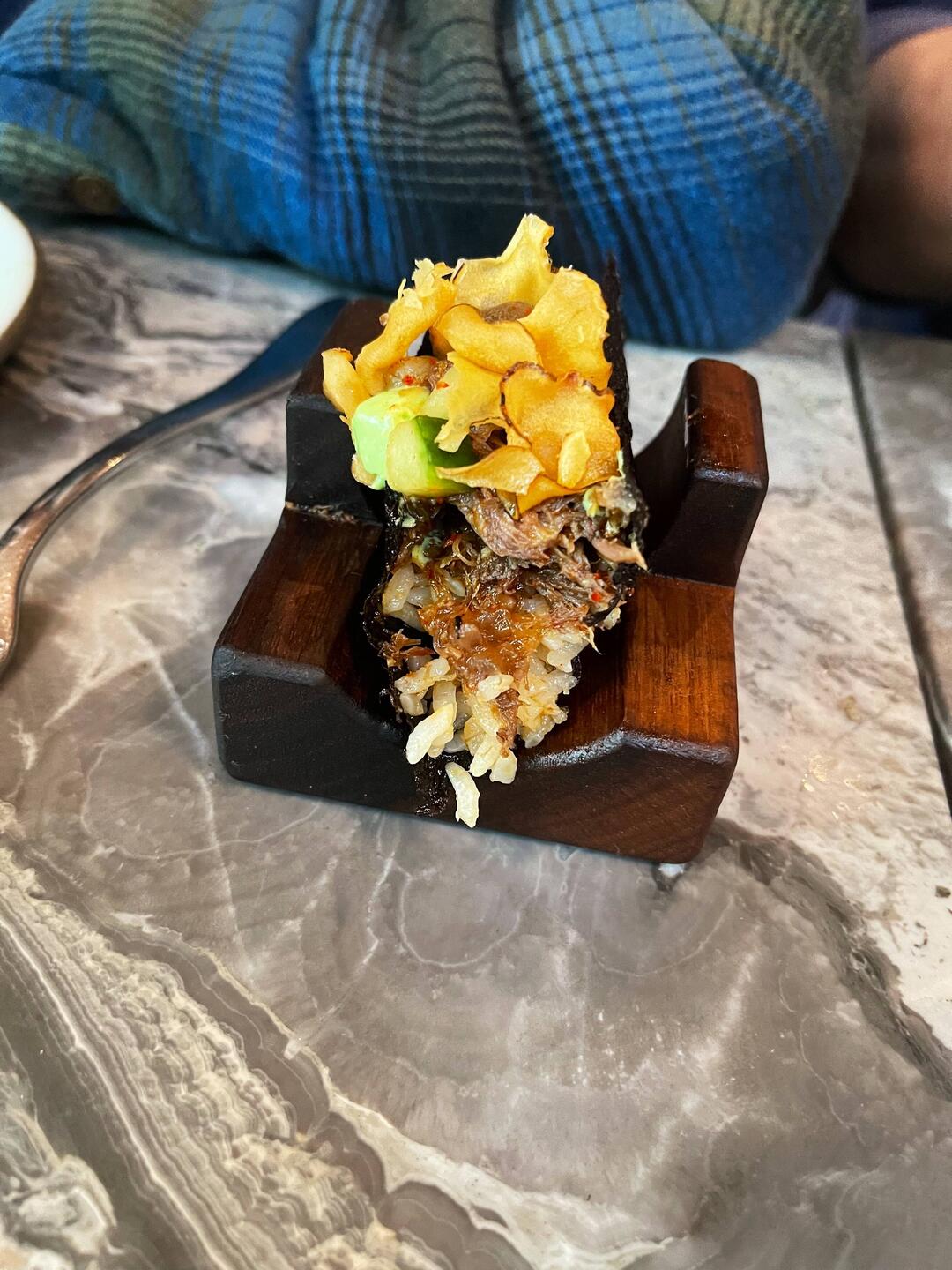 Oxtail taco with rice, potato chips, melon ice cream flavor dollop, seaweed wrap
