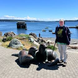 Photo op with Three Otter statue. Also note kids rowing in Northwest Maritime program.