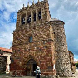 Carolyn walking up to a church in a village a few km outside of Le Puy