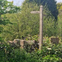 A signpost on the way up the hill to The Old School Tea Rooms, Cheddleton