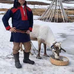Sami man and his reindeer.