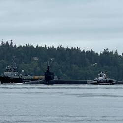 Tug Deception, and another support vessel at the submarine.