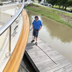 The Delaware City Marina dockmaster holds our bow line as we swivel stern-out