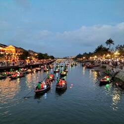 Busy riverside at sunset