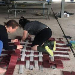 Making a hammock from fire hoses and plastic a very technical task