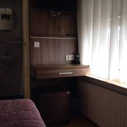 Total floor space width of desk, length of bed and door