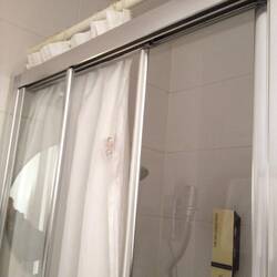 Shower door didn't work so they added a curtain (mildewed)