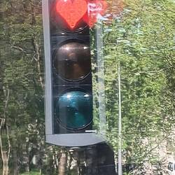 Heart-shaped red traffic signals in the city.