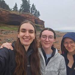 A selfie with the large rock formation at low tide