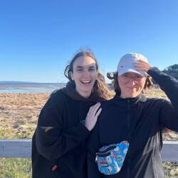 The wind is taking Erin's hat