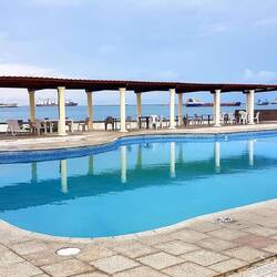 The New Washington Hotel swimming pool. Ships waiting for canal or port operations.