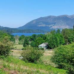 View of Troutdale cottages with Derwentwater and Skiddaw in the background
