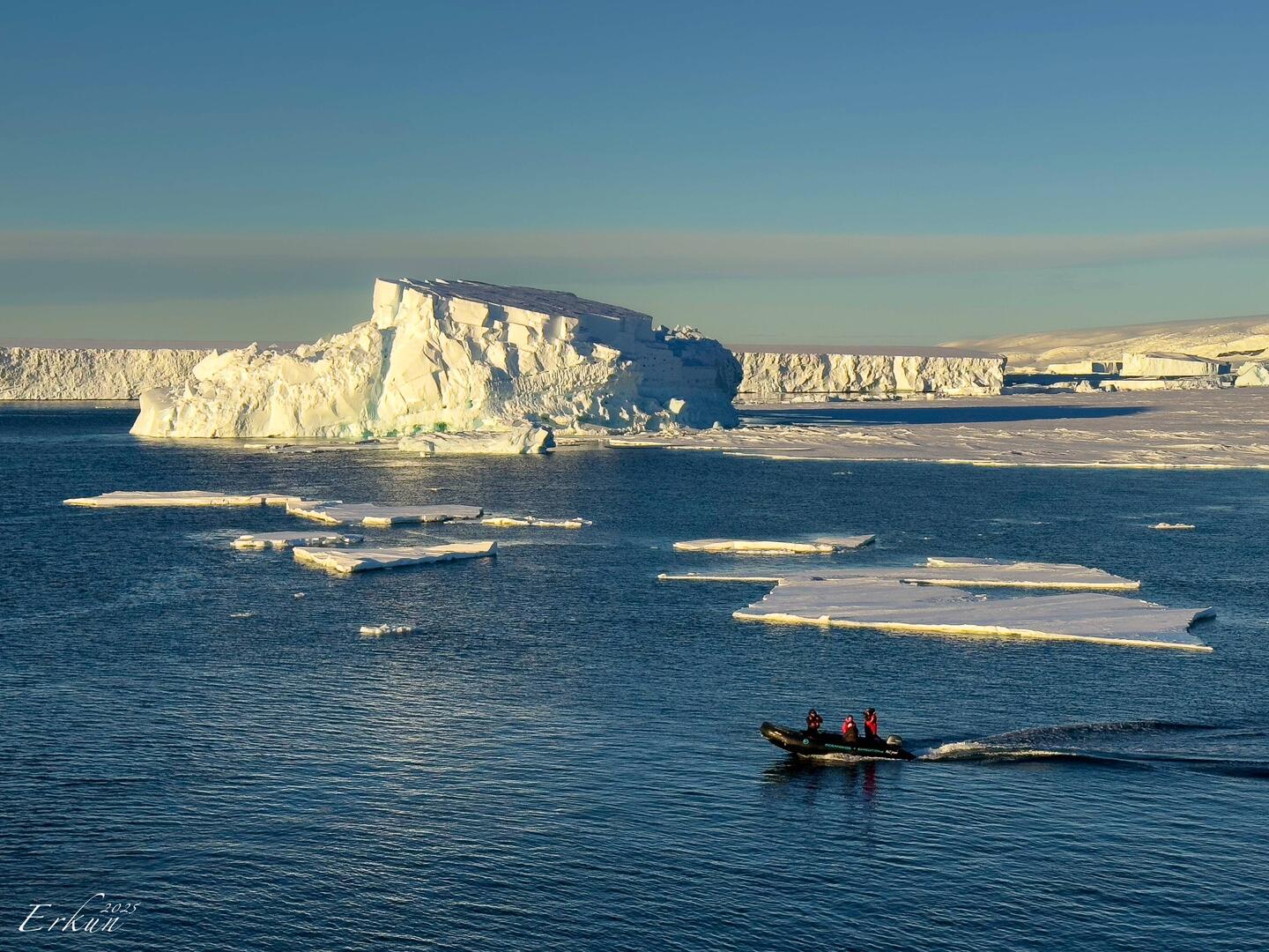 Expedition team returning to Ortelius as the sun bathes the scenery in a golden hue — Vahsel Bay.