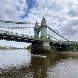 A bridge over the Thames River and a youth rowing club rowing beneath