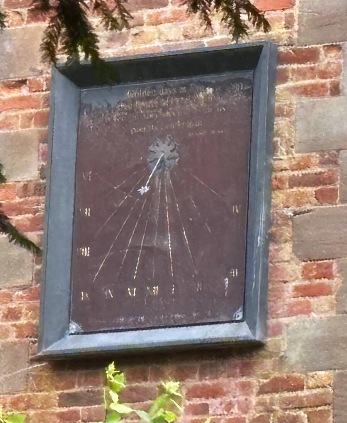 Sundial on side of old house