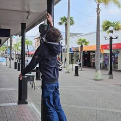 Thomas high-fiving some street art in Napier.