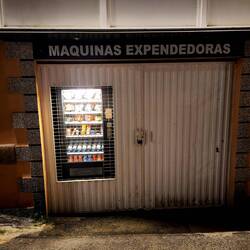 Vending machines are randomly on a side alleyway wall.