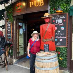 Beth posing outside the Canadian Pub with a Mountie
