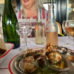 Beth amused at Nancy's first try of Escargot ... surprisingly Beth declined a bite!