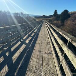 Loads of these bridges which have been maintained or upgraded to allow bikes to follow the rail.