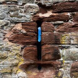 The iron yetts, numerous arrow slits and gun loops remind us of its defensive purpose.