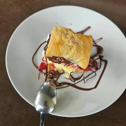 Sweet appetizer: mille fille with ice cream, whipped cream, berries and Nutella