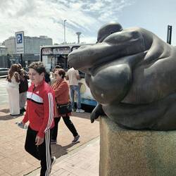 One boy walking away, blushing.