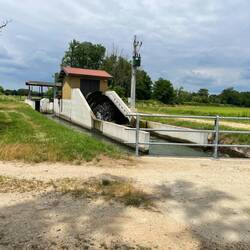 Water wheel to facilitate a step down in the canal and aerate the water