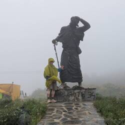 This large statue is about to lose his hat and my Poncho wants to fly away