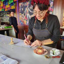 AThis lovely young woman is adding a wax stamp to our passports.