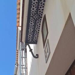 Even the balcony bases have mosaics. Saw this a lot in Seville.