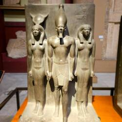 King Menkaura who built the third pyramid at Giza, flanked by goddesses Hathor and the Jackal-nome