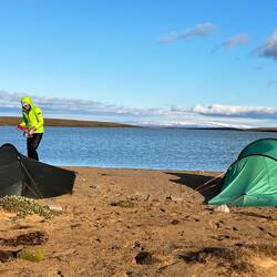 Pitched for the night. Weighed down with stones. An icecap in the far distance